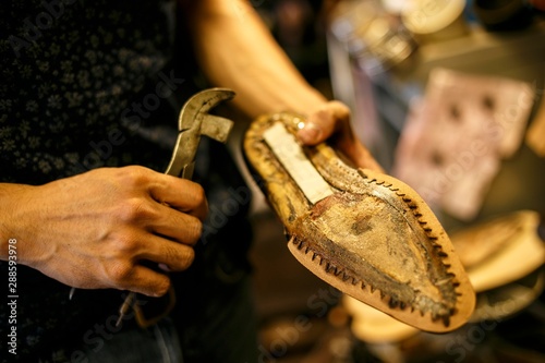 shoe repair craftsman in his studio