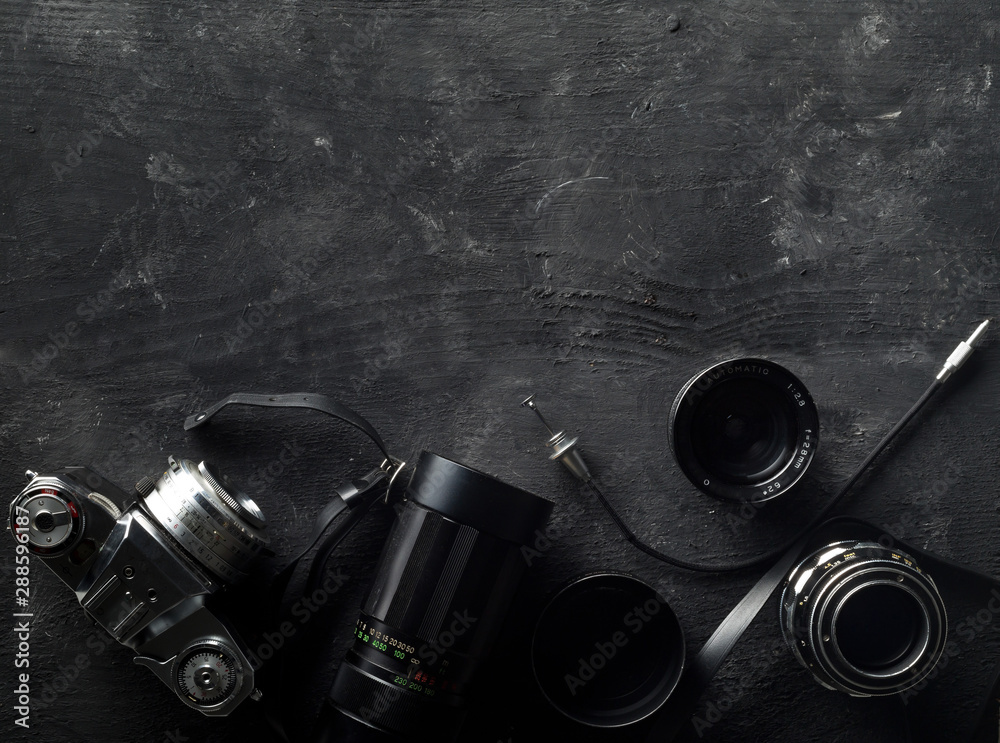 Retro analog film camera with lenses and photography equipment on dark wooden background with copy space - photography or creativity concept, flat lay top view from above - obrazy, fototapety, plakaty 