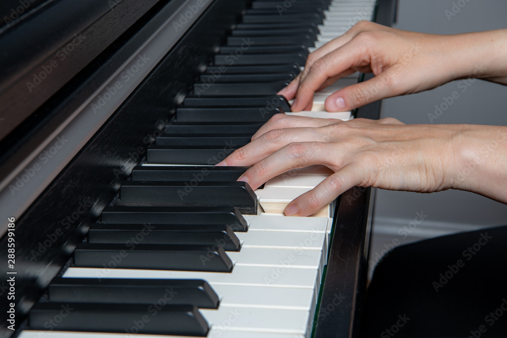 Close uClose up of a woman playing the piano. Left hand only plays a melody, one note at a time.p of a woman playing the piano. Left hand plays a Power Chord and right hand plays the melody. Close uClose up of a woman playing the piano. Left hand only plays a melody, one note at a time.p of a woman playing the piano. Left hand plays a Power Chord and right hand plays the melody.