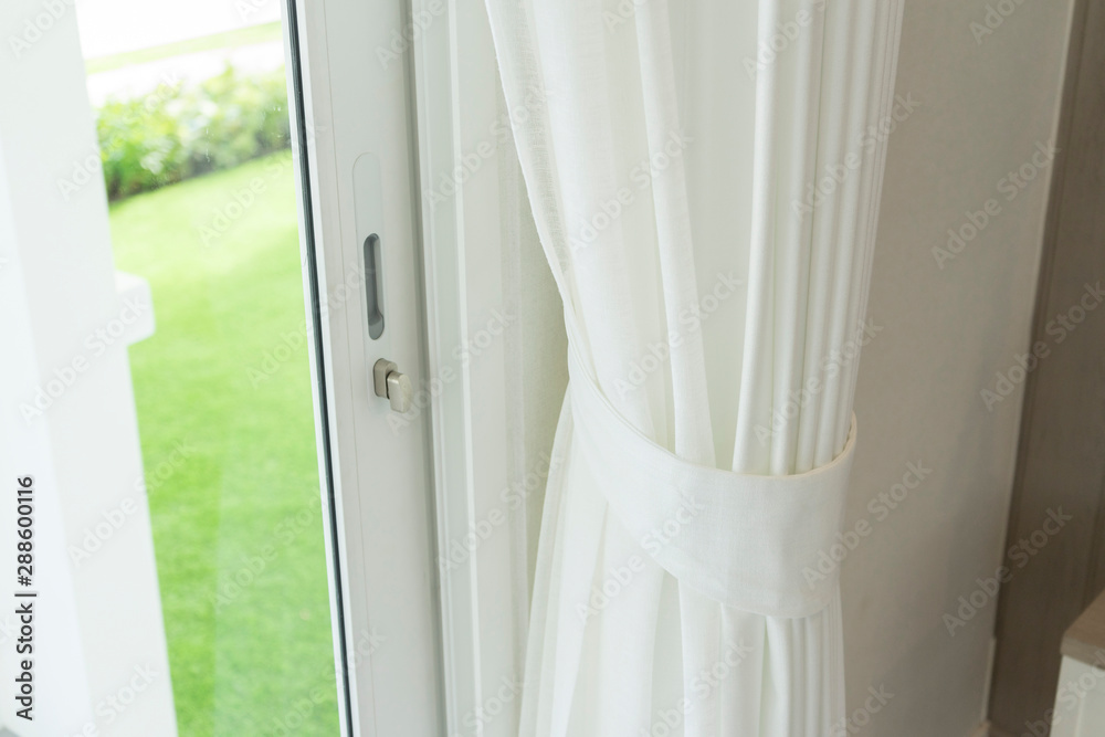 Close up of white modern curtain detail of Holder, interior detail. Close up of white modern curtain detail of Holder, interior detail.