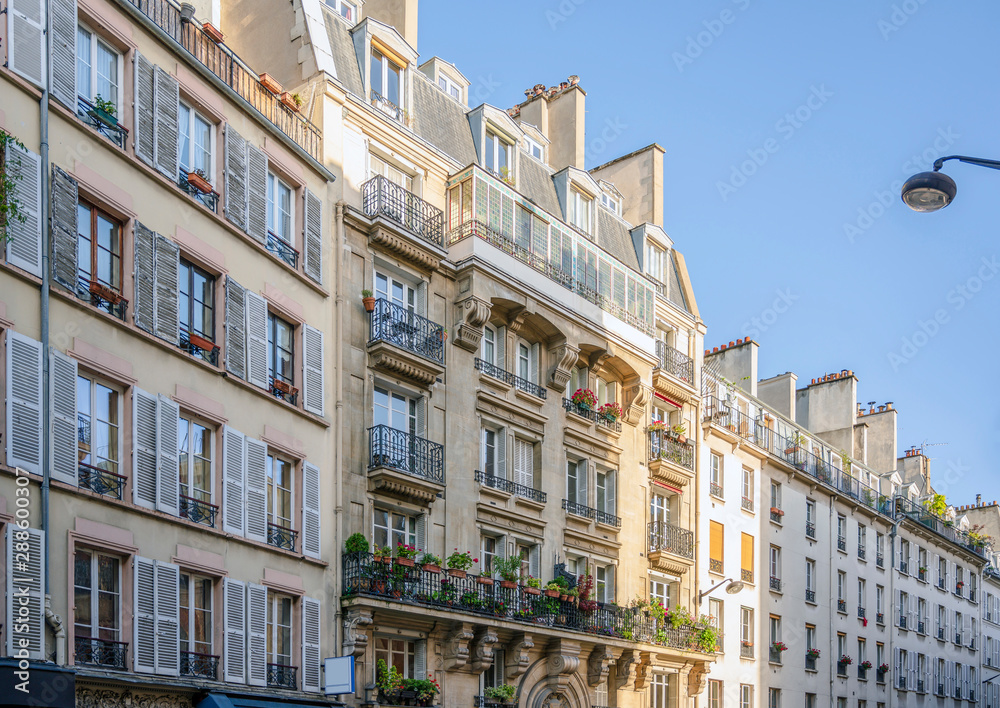 Paris street residential apartment buildings with balconies and window shutters