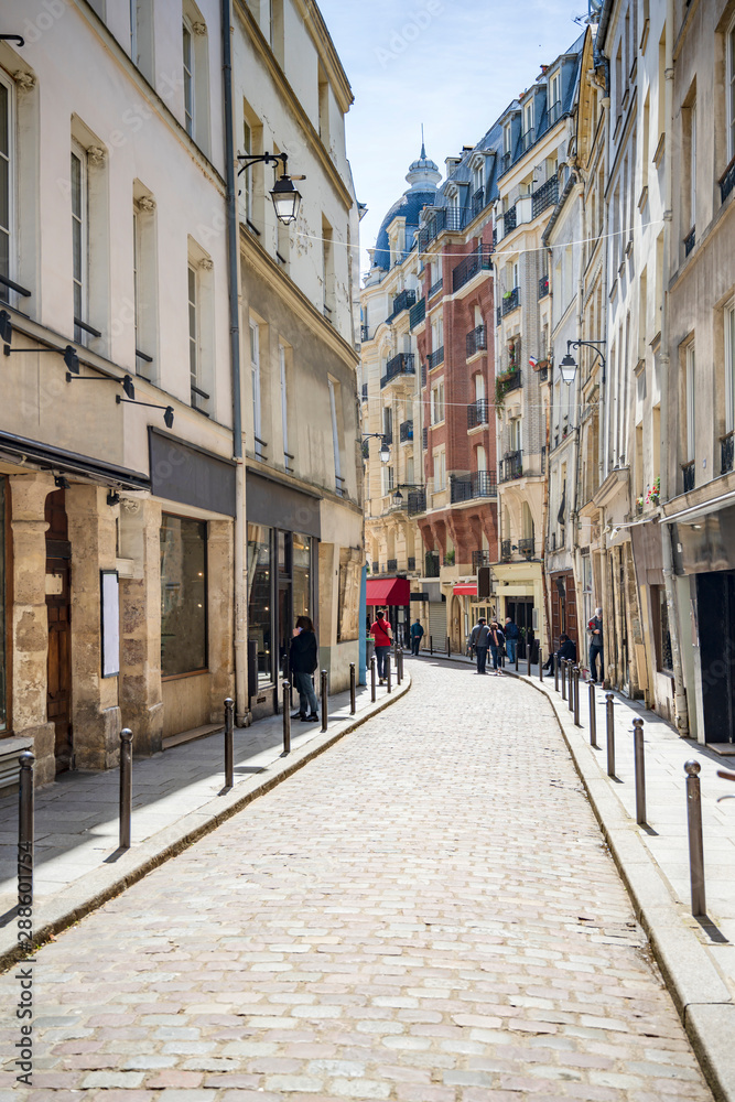 Residential street of old Paris with business premises on the ground floor of buildings