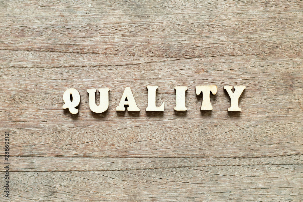 Letter block in word quality on wood background Letter block in word quality on wood background