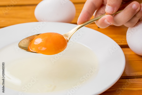 白いお皿に生卵の黄身がスプーンから落ちる瞬間 料理 Stock Photo Adobe Stock