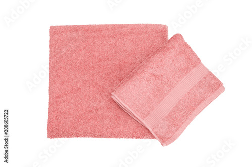 Bath folded towels isolated on a white background. Pink color. Spa treatments for body.  Top view. Flat lay. Factory textile. Body towels
