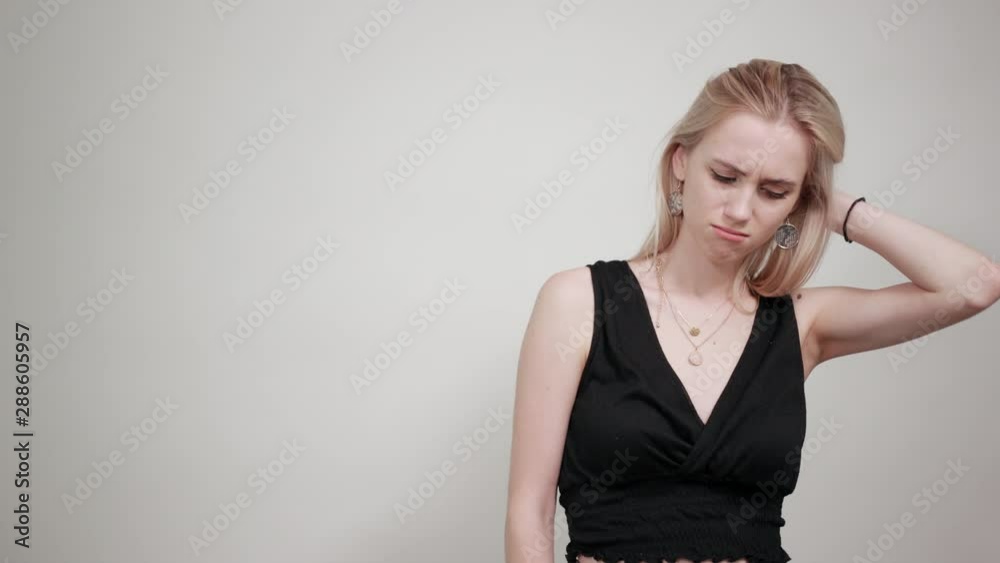 blonde girl in a black dress over isolated white background shows emotions blonde girl in a black dress over isolated white background shows emotions