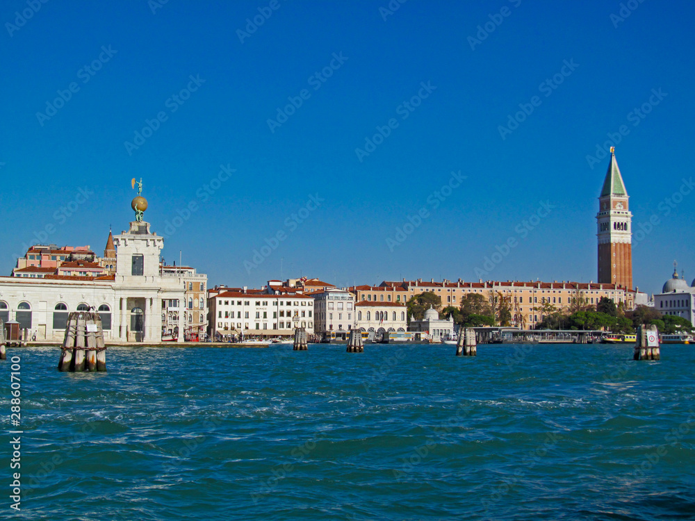 Grand Canal in Venice, Italy. Scenic panoramic view on Venetian landmarks - water surface and seafront with buildings and architecture attractions. 