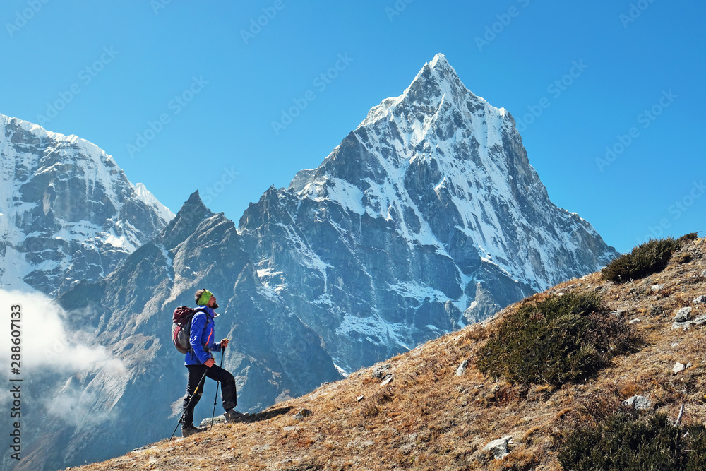Hiker walking in the mountains, freedom and happiness, achievement in mountains. Himalayas, Nepal
