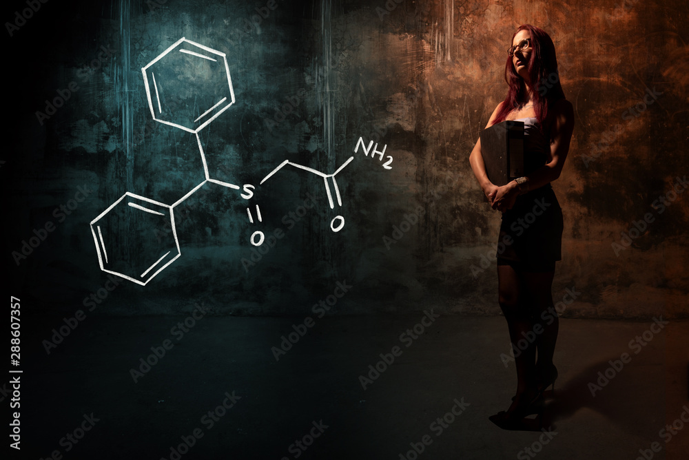 Sexy girl or secretary or female student presenting handdrawn chemical formula of Modafinil Sexy girl or secretary or female student presenting handdrawn chemical formula of Modafinil