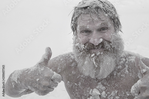 Bearded man, after bathing in the snow photo