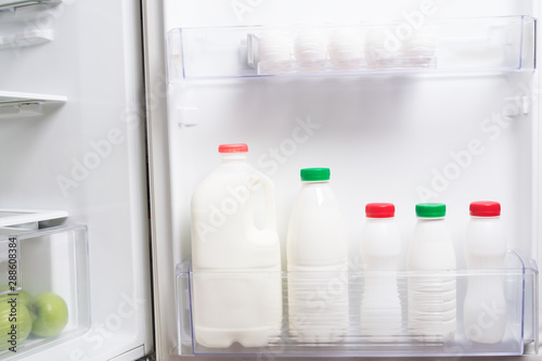 in the refrigerator door are bottles of milk drinks and eggs