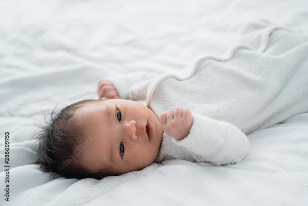 cute little infant newborn baby on white bed cute little infant newborn baby on white bed