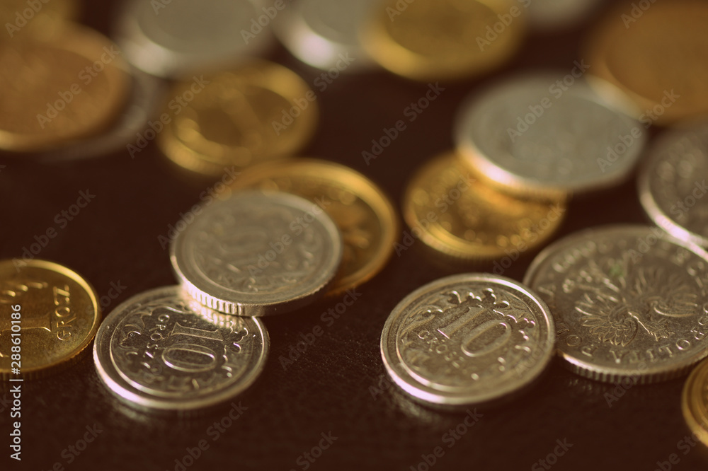 Polish coins scattered on a dark background close up. Retro style Polish coins scattered on a dark background close up. Retro style
