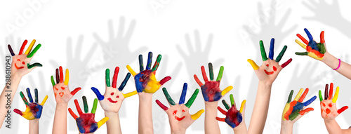 Children s smiling colorful hands raised up. The concept of classroom or back to school