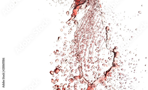flying splashes, jets and drops of red wine hovering in the air on a white background