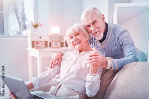 Couple of cute elderly man and woman hugging each other