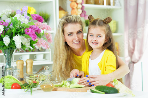 Portrait of smiling mother and daughter cooking together