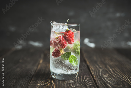 Raspberry mojito cocktail on the rustic background. Selective focus. Shallow depth of field.