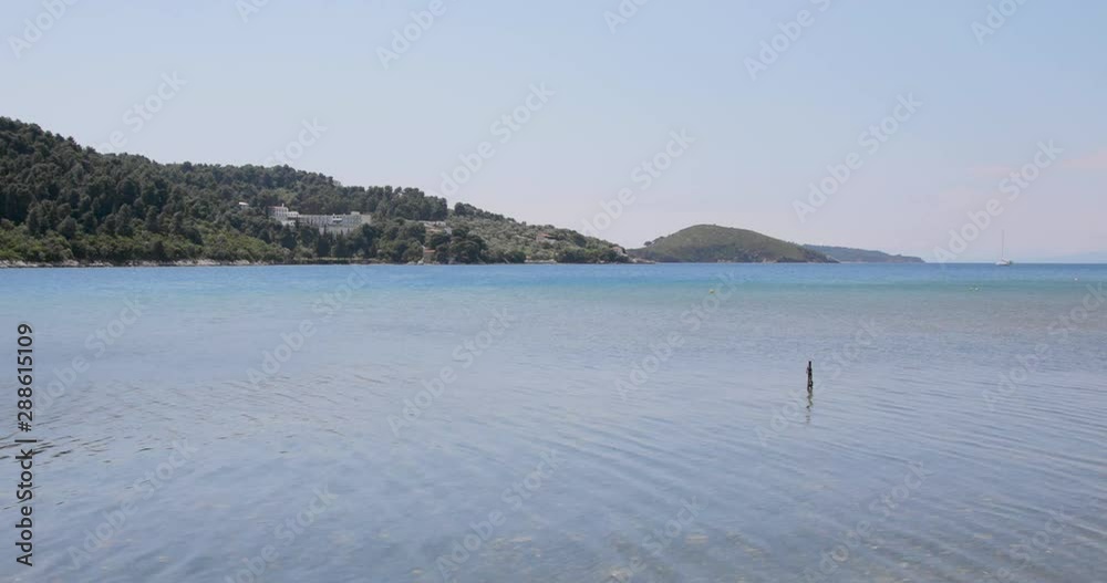 Wide of a green hills and water in foreground Wide of a green hills and water in foreground