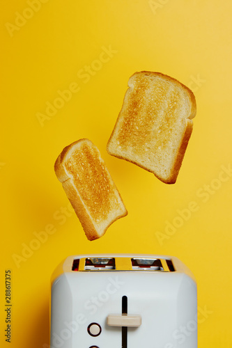 Photo Slices of toast jumping out of the toaster