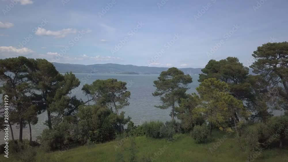 Drone aerial video of the small ancien Castiglione del Lago village, in Umbria region, Italy at summer Drone aerial video of the small ancien Castiglione del Lago village, in Umbria region, Italy at summer