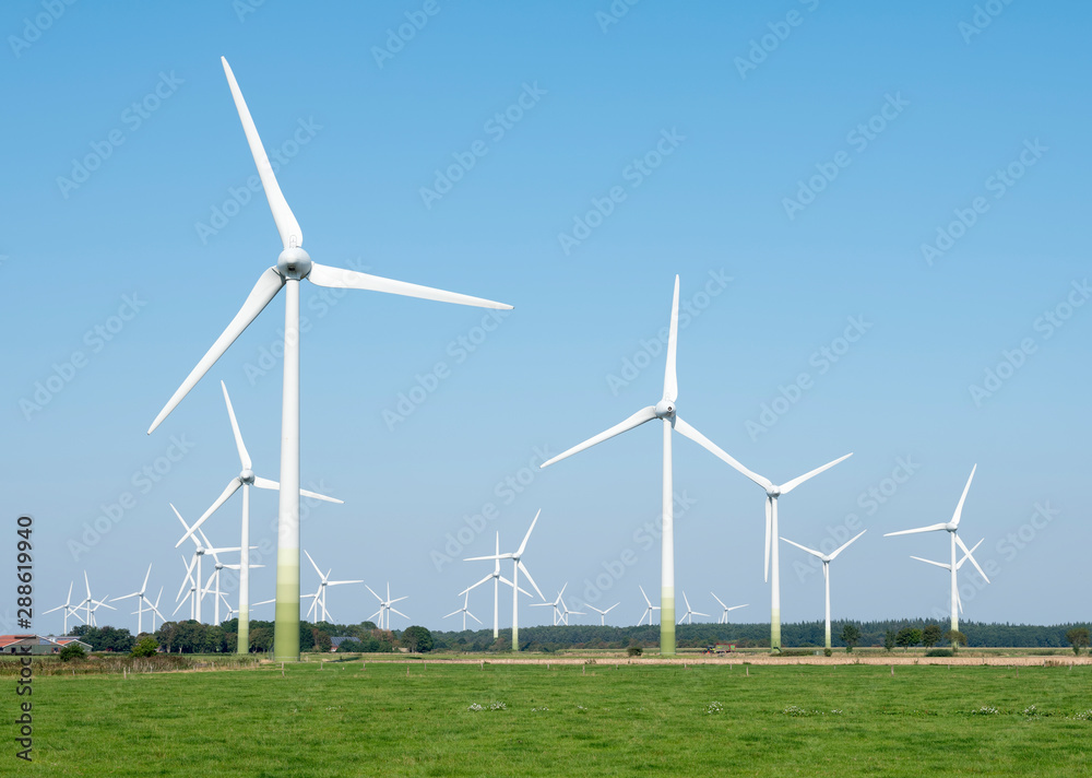 wind turbines in rural landscape of ostfriesland in the north of germany and blue sky wind turbines in rural landscape of ostfriesland in the north of germany and blue sky