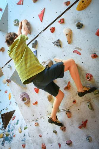 Teenage Boy Training On Climbing Wall