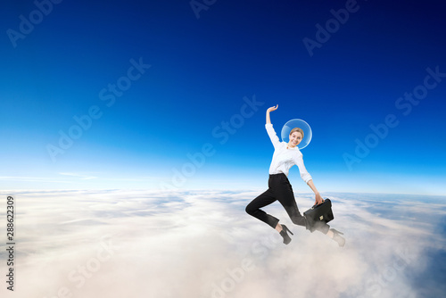 Businesswoman in spacesuit on the head flying in stratosphere.