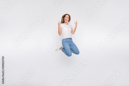 Full length body size photo of young beautiful attractive pretty rocker girlfriend impressed with new metal band while isolated with white background
