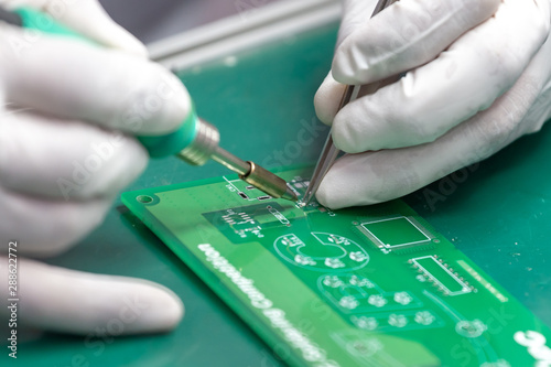 hand soldering on green table photo