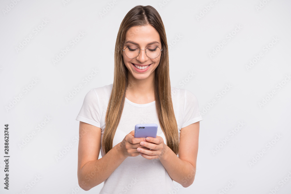 Amazing lady holding telephone in hands wear specs and casual t-shirt isolated white background Amazing lady holding telephone in hands wear specs and casual t-shirt isolated white background