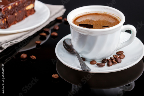 Fototapeta Naklejka Na Ścianę i Meble -  Cup of coffee on a black glass table