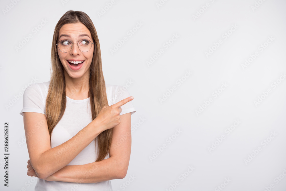 Photo of pretty lady indicating finger empty space wear specs and t-shirt isolated white background Photo of pretty lady indicating finger empty space wear specs and t-shirt isolated white background