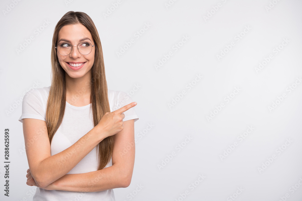 Salesperson lady indicating finger empty space on sale banner wear specs and t-shirt isolated white background Salesperson lady indicating finger empty space on sale banner wear specs and t-shirt isolated white background