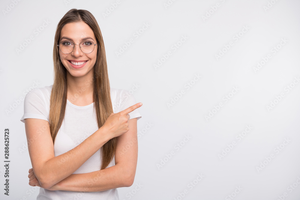 Photo of pretty lady indicating finger empty space wear specs and t-shirt isolated white background Photo of pretty lady indicating finger empty space wear specs and t-shirt isolated white background