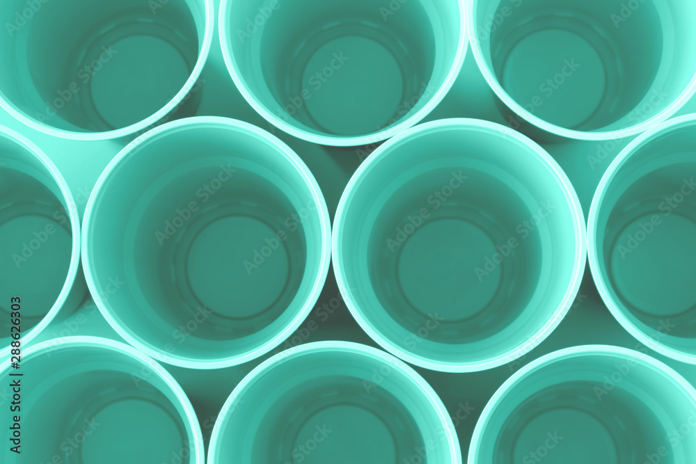 Disposable plastic neon mint cups background. Top view of single-use glasses. Plastic concept. Disposable plastic neon mint cups background. Top view of single-use glasses. Plastic concept.