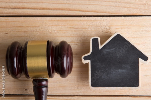 Real estate concept -auction gavel and little house