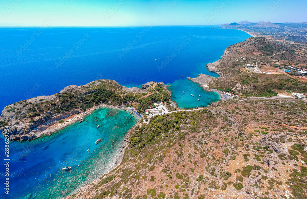 Aerial birds eye view drone photo Anthony Quinn and Ladiko bay on Rhodes island, Dodecanese, Greece. Panorama with nice lagoon and clear blue water. Famous tourist destination in South Europe