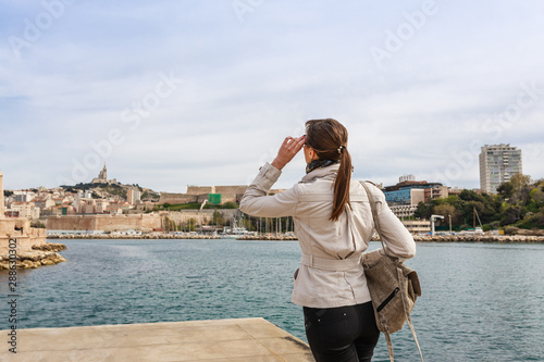 Obraz na płótnie Tourist woman in French historical city Marseille and Mediterranean sea coast. Marseille is the biggest port in France, South Europe. Famous large city and tourist destionation. w salonie