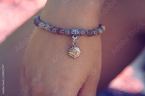 Female hand wearing mineral stone beads yoga bracelet