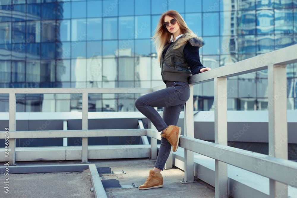 Outdoor lifestyle portrait of pretty young girl, wearing in hipster swag grunge style urban background.