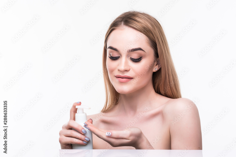 Portrait of beautiful woman smiling while taking some facial cream isolated on white background Portrait of beautiful woman smiling while taking some facial cream isolated on white background