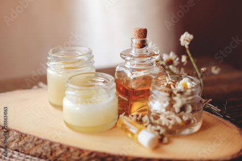 Hand cream and lip balm in a glass jar. Natural organic cosmetics with honey, wax and oils.