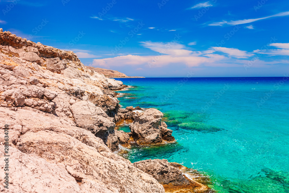 Sea skyview landscape photo near Agia Agathi beach and Feraklos castle on Rhodes island, Dodecanese, Greece. Panorama with sand beach and clear blue water. Famous tourist destination in South Europe