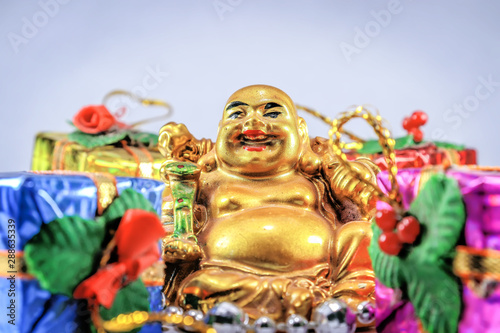 Laughing Buddha with attractive smile and gifts
