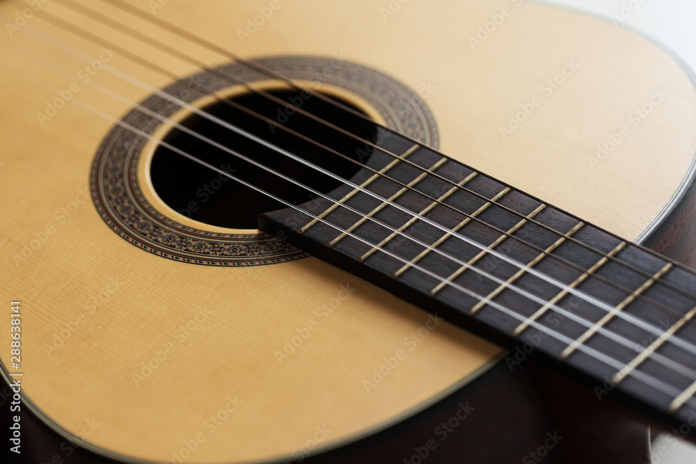 Close-up Wooden Spanish classic guitar with nylon string select focus shallow depth of field Close-up Wooden Spanish classic guitar with nylon string select focus shallow depth of field