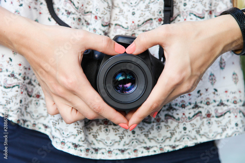 Foto Girl photographer with reflex camera