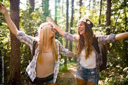 Happy woman with friends hiking in the forest © NDABCREATIVITY