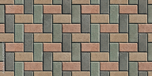 The surface is lined with colorful road tiles - paving stone. View from above. Specially prepared background for seamless shading.