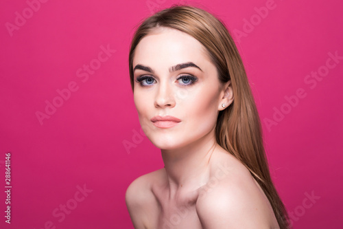 Beautiful face of a young caucasian woman skin care concept, isolated on pink background